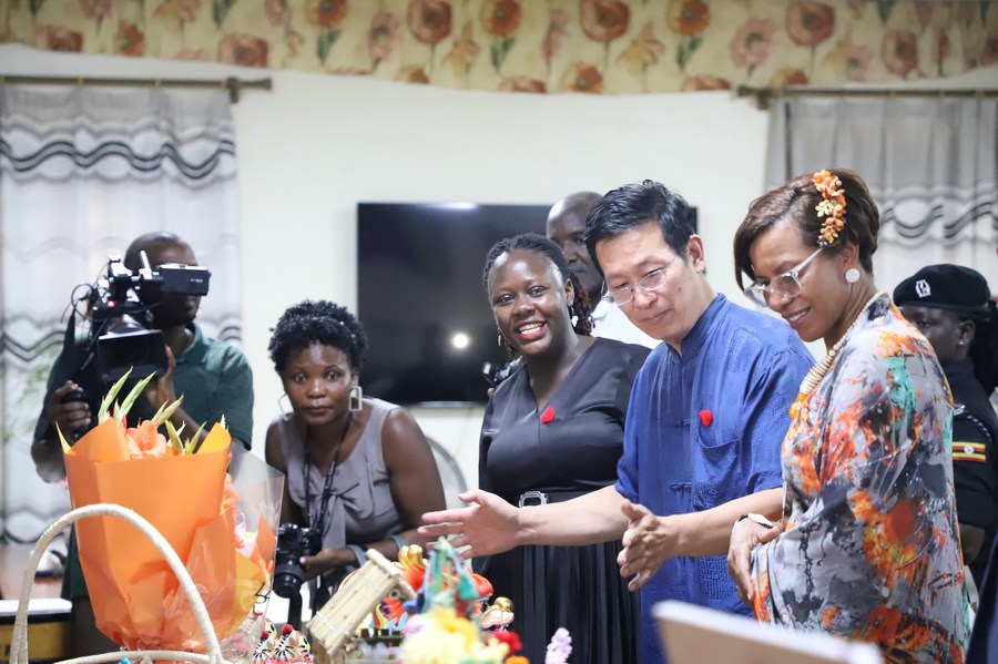 Chinese ambassador to Uganda Zhang Lizhong (2nd R front), flanked by local guests, tours the exhibition at the newly launched Luyanzi Uganda-China Cultural Exchange Center at Luyanzi Institute of Technology, district of Wakiso, Uganda on March 8, 2024. (Photo by Nicholas Kajoba/Xinhua)