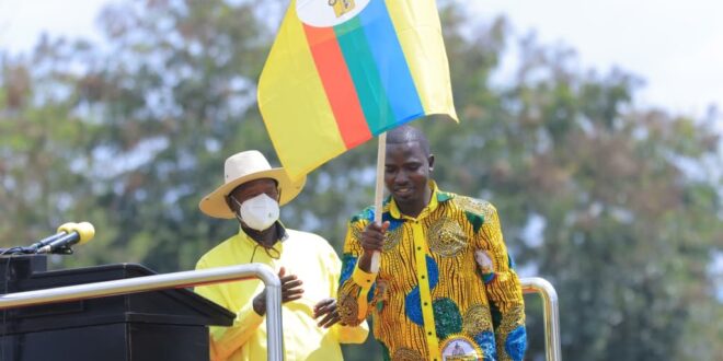 M7 hands over a flag to youthful Energetic Wakooli Matembu