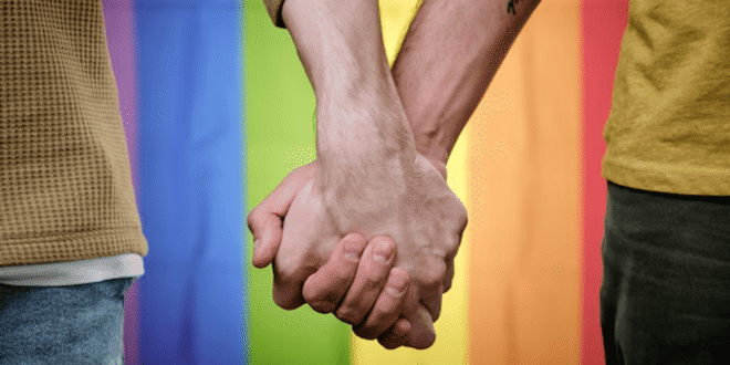 Two men holding hands. (Photo courtesy of Mimoun Kabdani)