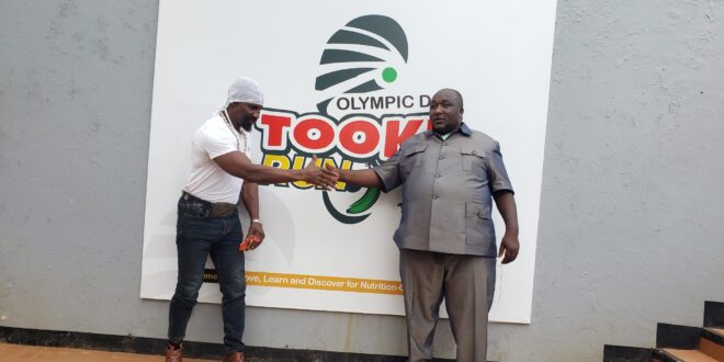 Golola Moses visits PIBID offices to support Bushenyi Tooke Run